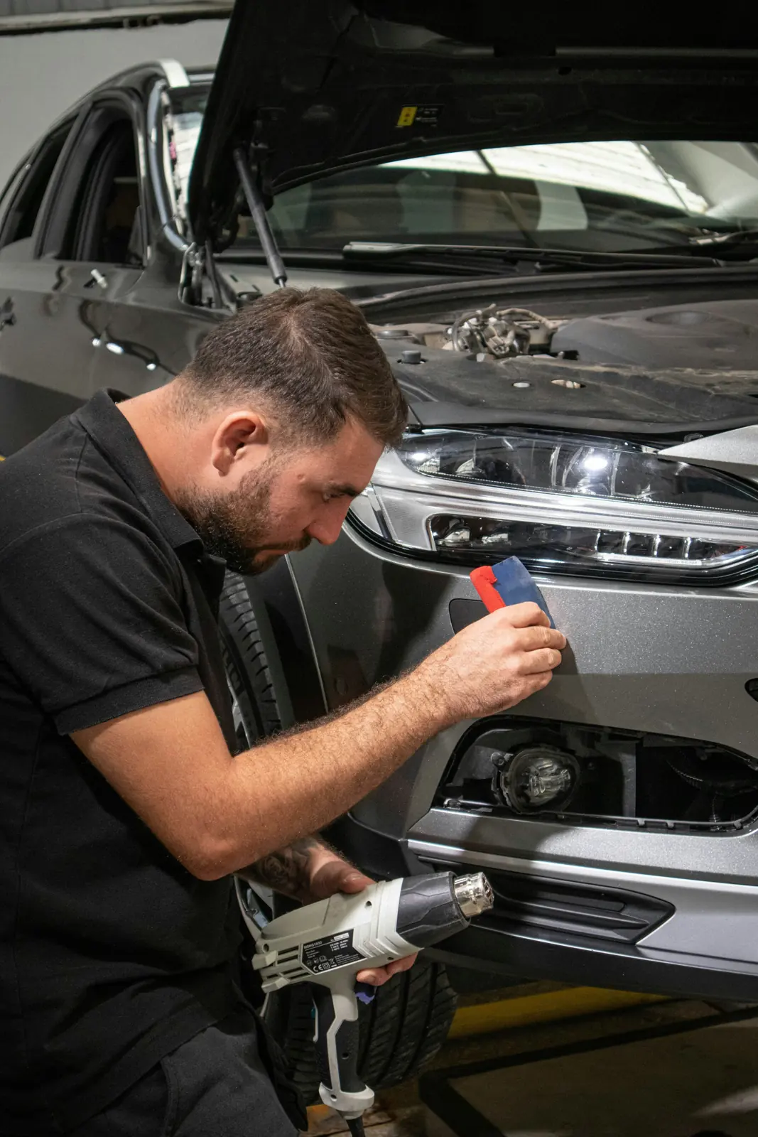 Claims assessor inspecting a vehicle